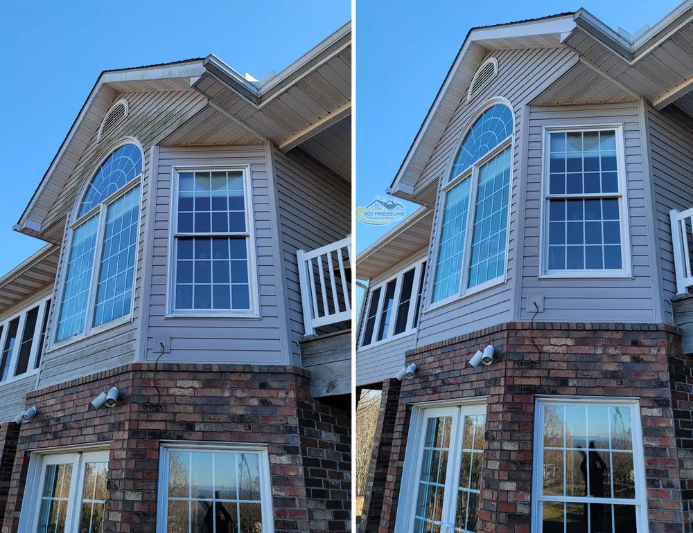 A bay window on a brick and siding house: green growth on the siding and soffit on the left, clean on the right